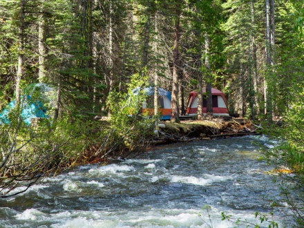 tent campsites next to flowing river