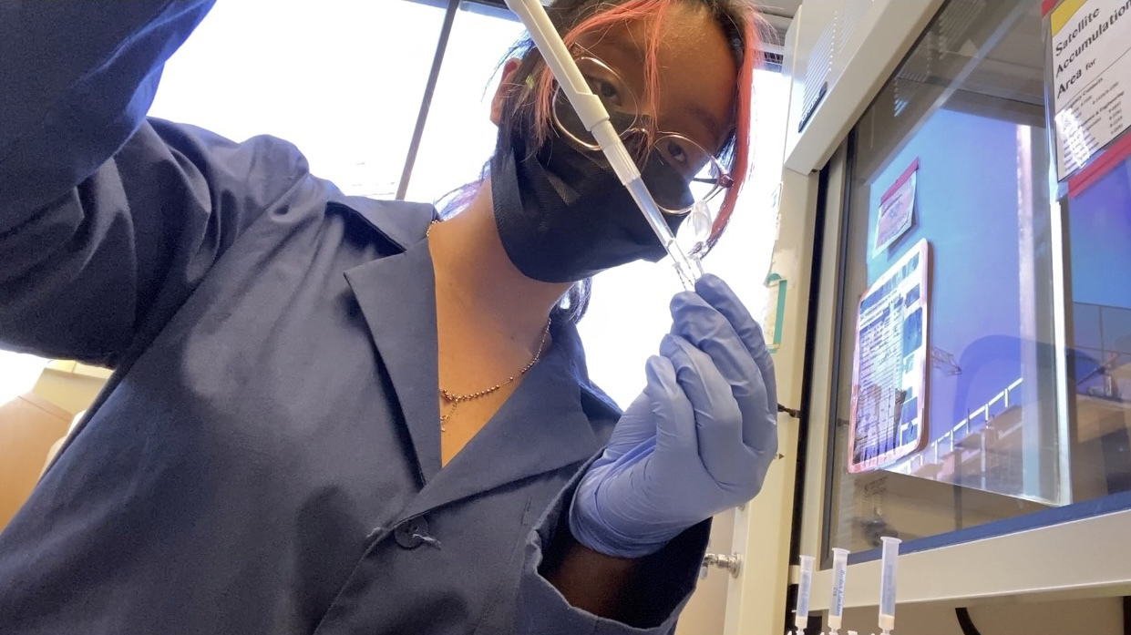 Adriana Mejia Lopez in lab with pipetter