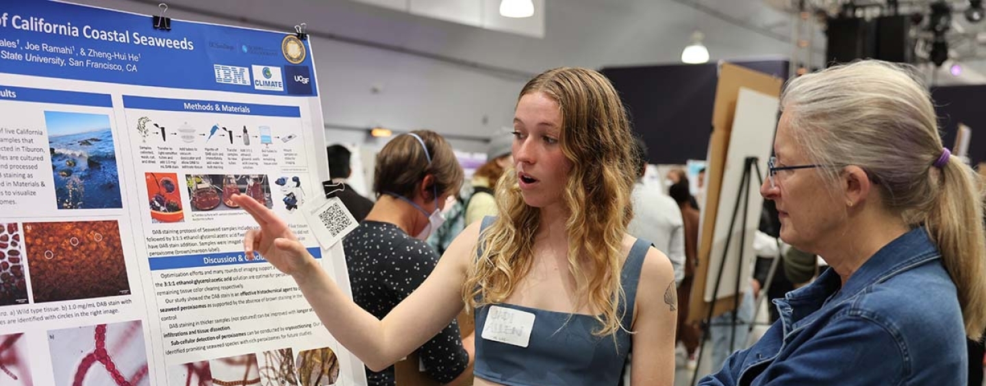 Student Jadi Allen showing her research poster to Biology Professor Gretchen LeBuhn