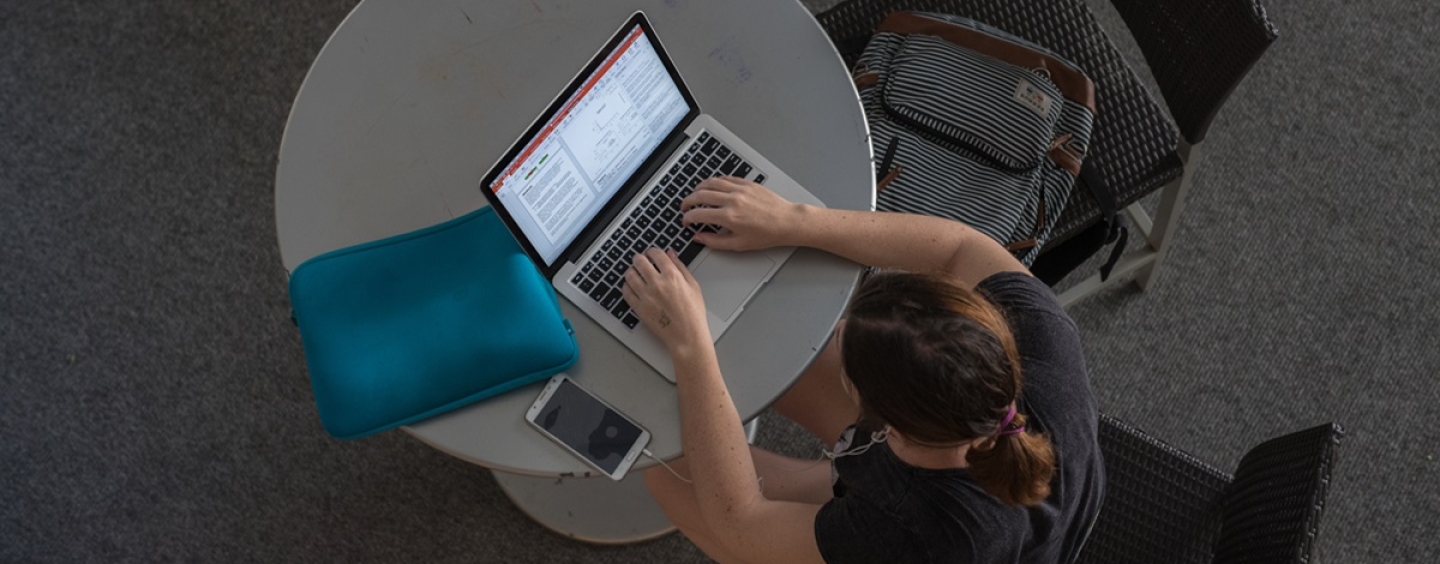 Overhead view of a person working on a laptop