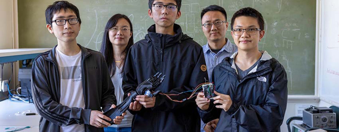 SF State faculty with some of the student researchers holding their bonic arm and Sony microprocessor.