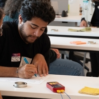 Three students at a table working on an activity together in the classroom