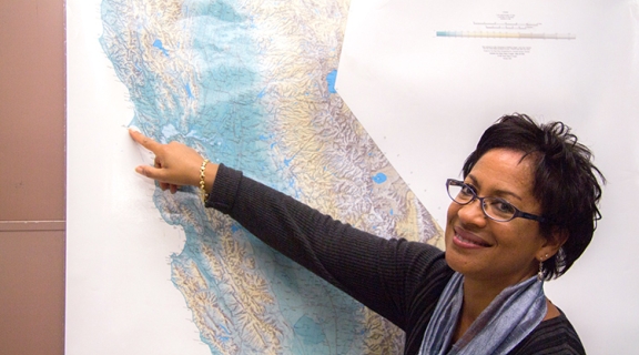 Dr. Lisa White points at Pt Reyes on a map of California